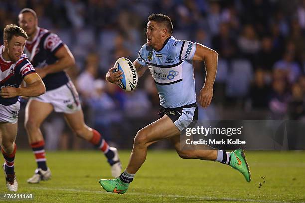 Chris Heighinton of the Sharks runs the ball during the round 13 NRL match between the Sharks and the Roosters at Remondis Stadium on June 7, 2015 in...