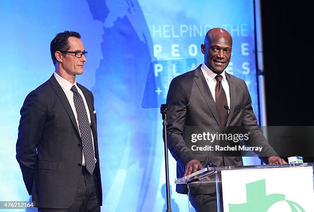 Sebastian Copeland and actor Peter Mensah speak onstage during the Global Green USA 19th Annual Millennium Awards on June 6, 2015 in Century City,...