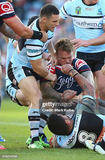 Michael Gordon of the Sharks pulls away Jake Friend of the Roosters as he scuffles with Andrew Fifita of the Sharks during the round 13 NRL match...