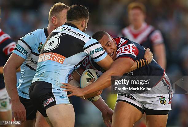 Sio Siua Taukeiaho of the Roosters is tackled during the round 13 NRL match between the Sharks and the Roosters at Remondis Stadium on June 7, 2015...