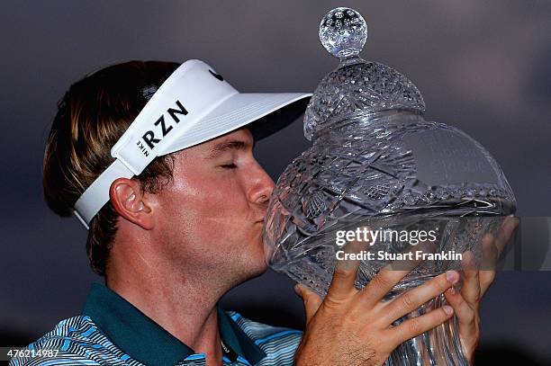 Russell Henley celebrates with the trophy after winning The Honda Classic at PGA National Resort and Spa on March 2, 2014 in Palm Beach Gardens,...