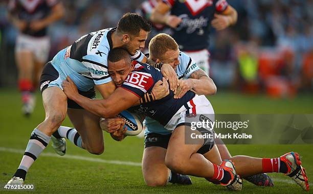 Sio Siua Taukeiaho of the Roosters is tackled during the round 13 NRL match between the Sharks and the Roosters at Remondis Stadium on June 7, 2015...