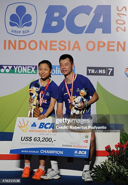 Xu Chen and Ma Jin of China pose on the podium after winning Mixed Double's Final in the 2015 BCA Indonesia Open at Istora Senayan on June 7, 2015 in...