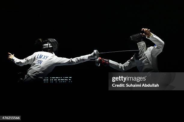 Hanniel Abella of Philippines fights Lim Xiu Yan Victoria Ann of Singapore in the women's fencing team epee semifinals at the OCBC Arena Hall during...