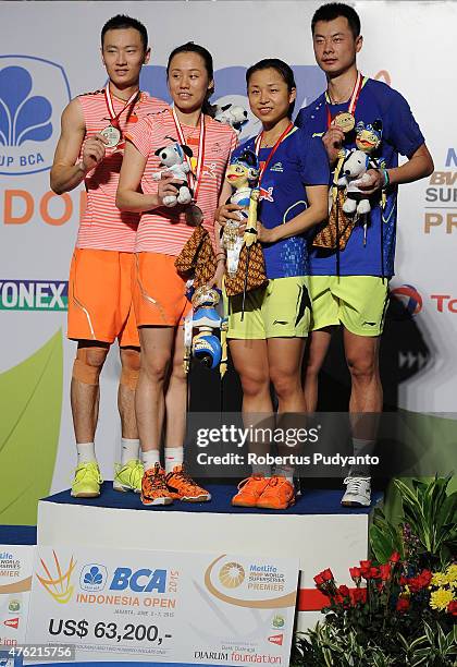 Zhang Nan-Zhao Yunlei of China and Xu Chen-Ma Jin of China pose on the podium during Mixed Double's awarding ceremony in the 2015 BCA Indonesia Open...