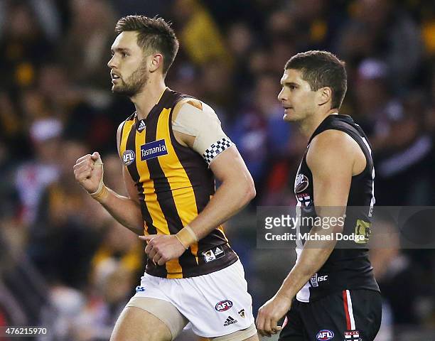 Jack Gunston of the Hawks celebrates a goal next to Leigh Montagna of the Saints during the round 10 AFL match between the St Kilda Saints and the...