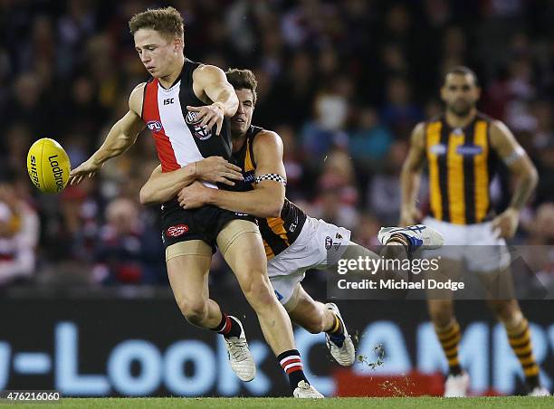 Jack Billings of the Saints is tackled by Ben Stratton of the Hawks during the round 10 AFL match between the St Kilda Saints and the Hawthorn Hawks...