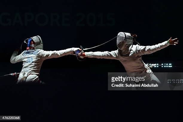 Diah Permatasari of Indonesia fights Sirawalai Starrat of Thailand in the women's fencing team sabre semifinals at the OCBC Arena Hall during the...