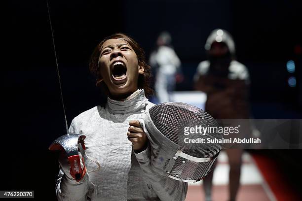Patsara Manuya of Thailand reacts during her fight with Novi Susanti of Indonesia in the women's fencing team sabre semifinals at the OCBC Arena Hall...