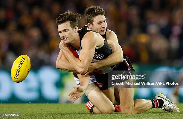 Dylan Roberton of the Saints is tackled by Liam Shiels of the Hawks during the 2015 AFL round ten match between the St Kilda Saints and the Hawthorn...
