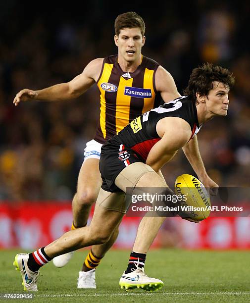 Farren Ray of the Saints is chased by Luke Breust of the Hawks during the 2015 AFL round ten match between the St Kilda Saints and the Hawthorn Hawks...