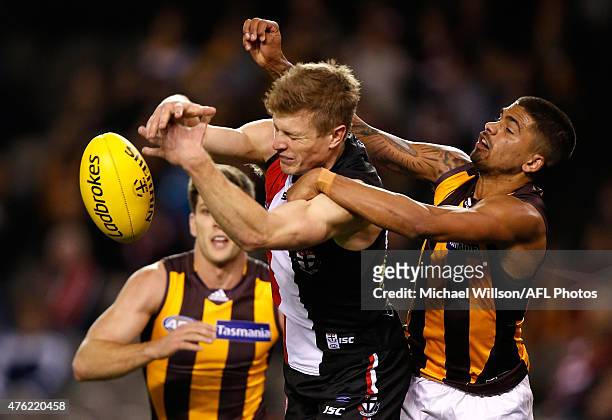 Jack Newnes of the Saints and Bradley Hill of the Hawks compete for the ball during the 2015 AFL round ten match between the St Kilda Saints and the...