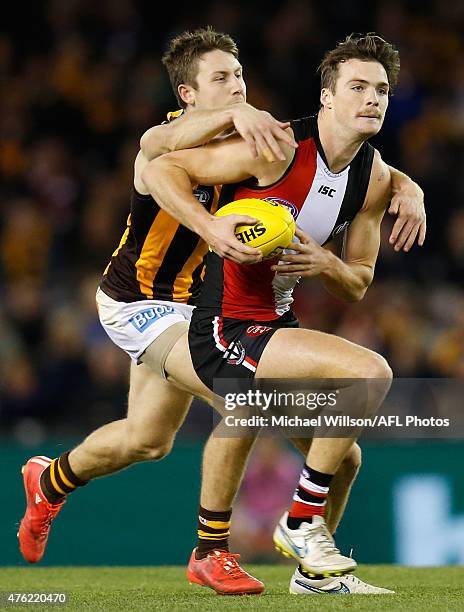 Dylan Roberton of the Saints is tackled by Liam Shiels of the Hawks during the 2015 AFL round ten match between the St Kilda Saints and the Hawthorn...