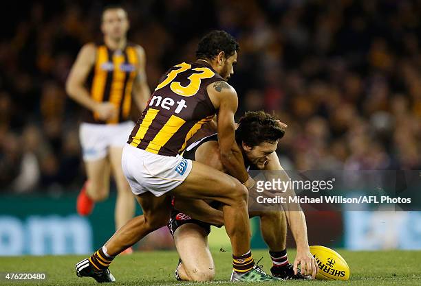 Cameron Shenton of the Saints is tackled by Cyril Rioli of the Hawks during the 2015 AFL round ten match between the St Kilda Saints and the Hawthorn...