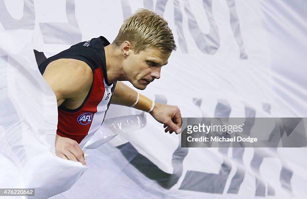 Nick Riewoldt of the Saints breaks through the banner during the round 10 AFL match between the St Kilda Saints and the Hawthorn Hawks at Etihad...