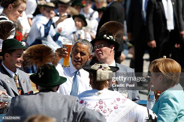 President Barack Obama enjoys a beer with German Chancellor Angela Merkel in the morning of the summit of G7 nations on June 7, 2015 in Kruen,...