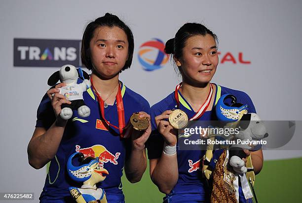 Tang Jinhua and Tian Qing of China pose on the podium after winning Women's Doubles of the 2015 BCA Indonesia Open at Istora Senayan on June 7, 2015...