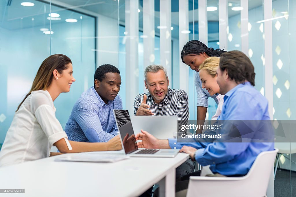 Large group of happy business people cooperating on a meeting.