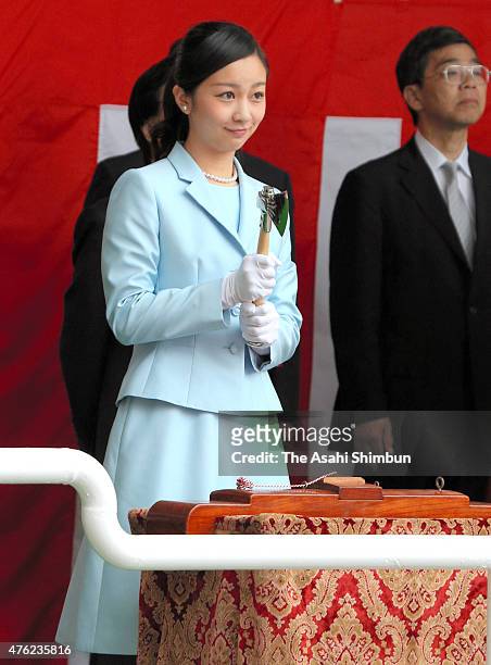 Princess Kako of Akishino cuts the rope with a small ax during the launching ceremony of the Japan Agency for Marine-Earth Science and Technology 's...