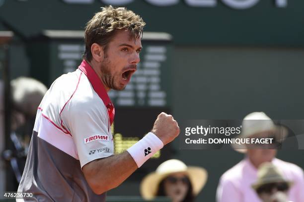 Switzerland's Stanislas Wawrinka reacts after a point against Serbia's Novak Djokovic during their men's final match of the Roland Garros 2015 French...