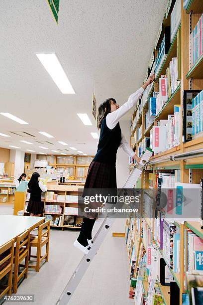 japanese high school, library. choosing a book, ladder - reaching higher stock pictures, royalty-free photos & images