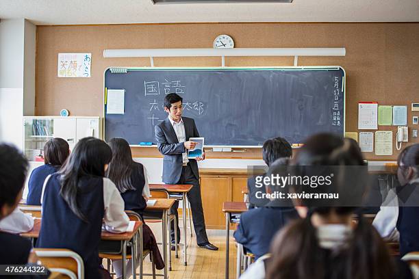 japanese teacher using a digital tablet on his class - japanese elementary school bildbanksfoton och bilder