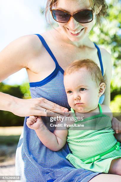 baby and mother applying sunscreen - baby suncream stock pictures, royalty-free photos & images