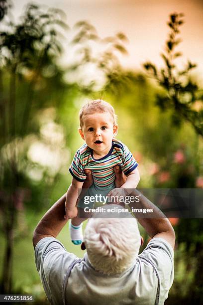grandfather and grandson - carrying-a-person-on-shoulders stock pictures, royalty-free photos & images