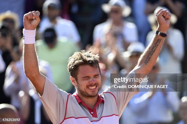 Switzerland's Stanislas Wawrinka celebrates his victory over Serbia's Novak Djokovic at the end of their men's final match of the Roland Garros 2015...