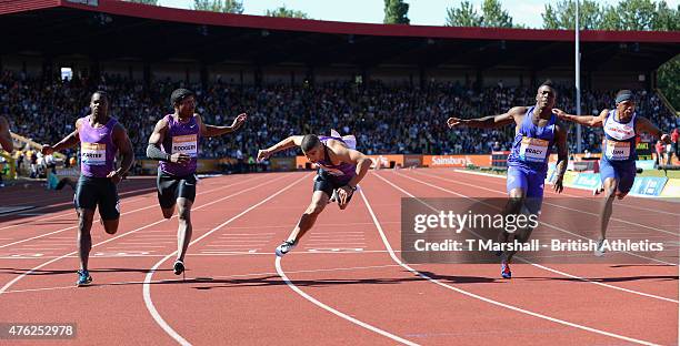 Adam Gemili of Great Britain falls as he crosses the finish line as Marvin Bracy of USA wins the Men's100m Final during the Sainsbury's Birmingham...