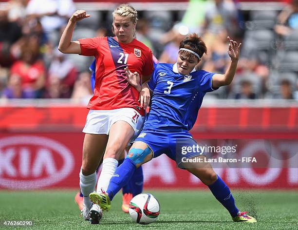 Ada Hegerberg of Norway is challenged Natthakarn Chinwong of Thailand during the FIFA Women's World Cup 2015 Group B match between Norway and...