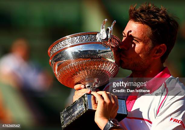 Stanislas Wawrinka of Switzerland poses with the Coupe de Mousquetaires after victory in the Men's Singles Final against Novak Djokovic of Serbia on...
