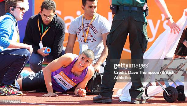 Adam Gemili of Great Britain is helped from the track after falling in the final of the men's 100metres during the Sainsbury's Birmingham Grand Prix...