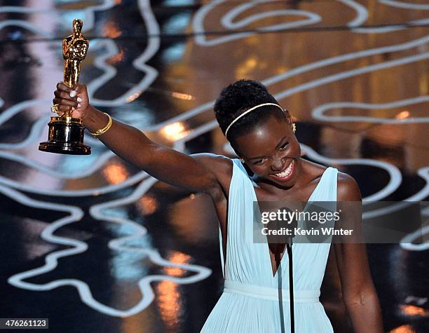 Actress Lupita Nyong'o accepts the Best Performance by an Actress in a Supporting Role award for '12 Years a Slave' onstage during the Oscars at the...