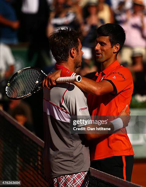 Stanislas Wawrinka of Switzerland is congratulated by Novak Djokovic of Serbia after victory in their Men's Singles Final on day fifteen of the 2015...