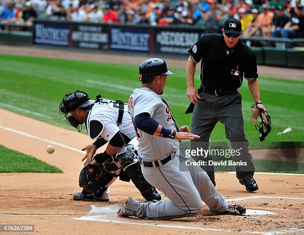 Miguel Cabrera of the Detroit Tigers scores as Geovany Soto of the Chicago White Sox takes the late throw during the first inning on June 7, 2015 at...