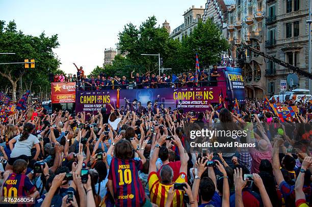 Barcelona players celebrate on an open top bus during their victory parade after winning the UEFA Champions League Final on June 7, 2015 in...