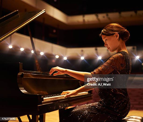 hitting the right notes - asian pianist stock pictures, royalty-free photos & images