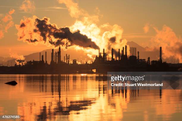 oil refinery at sunrise - oil refinery stock-fotos und bilder