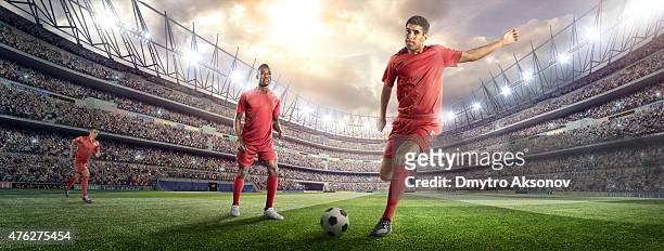 soccer player kicking ball in stadium - kicking ball stock pictures, royalty-free photos & images