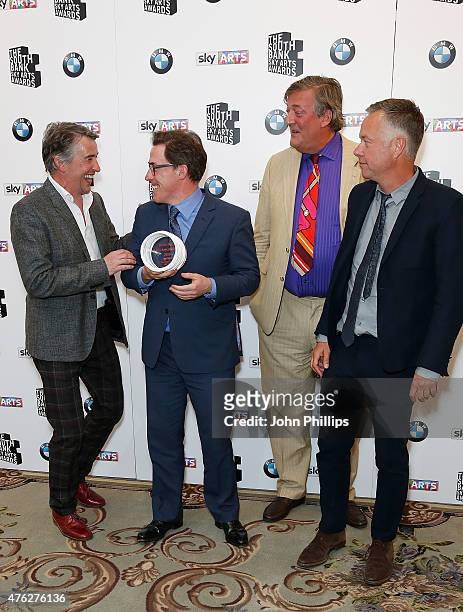 Stephen Fry poses with Rob Brydon, Steve Coogan and Michael Winterbottom, winners of the Comedy award for 'The Trip To Italy', in the press room at...