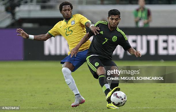 Brazil's Fred vies for the ball with Mexico's Jesus Manuel Corona during a friendly football match in preparation for the Copa America Chile 2015 at...