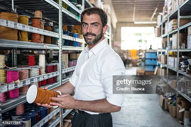 young man in his artisanal handicraft traditional textile factory - entrepreneur manufacturing stockfoto's en -beelden