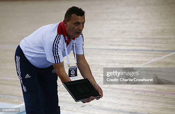 Coach Heiko Salzwedel holds information as Sir Bradley Wiggins of Great Britain and Team Wiggins tries to break the UCI One Hour Record at Lee Valley...