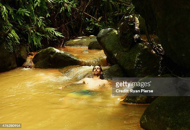 Mitchell Johnson of Australia swims in the hot springs during the Australian Cricket Team's visit to Trafalgar Falls on June 7, 2015 in Roseau,...