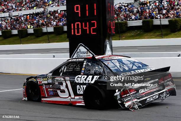 Ryan Newman, driver of the Grainger Chevrolet, drives his damaged car to the garage after being involved in an on-track incident during the NASCAR...