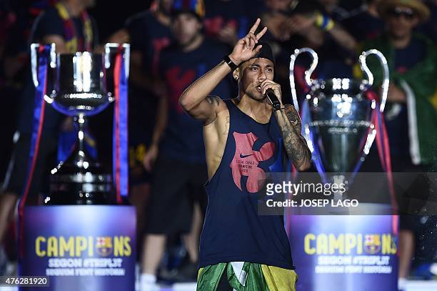 Barcelona's Brazilian forward Neymar da Silva Santos Junior delivers a speech as he takes part in the celebrations held for their victory over...