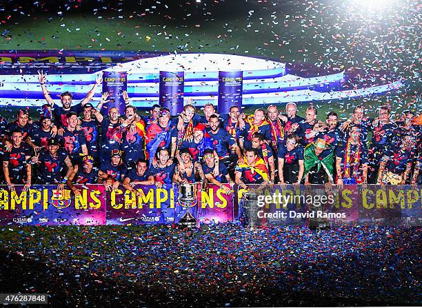 Barcelona players celebrate with La Liga, Copa del Rey and Champions League trophies during their victory parade after winning the UEFA Champions...