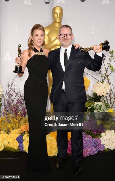 Director Morgan Neville and producer Caitrin Rogers, winners of Best Documentary, Feature pose in the press room during the Oscars at Loews Hollywood...