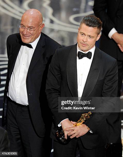 Producer Arnon Milchan and actor/producer Brad Pitt accept the Best Picture award for '12 Years a Slave' onstage during the Oscars at the Dolby...